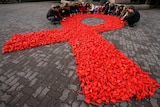 Activists of "Young medics of Russia" social organisation and city volunteers form a red ribbon.