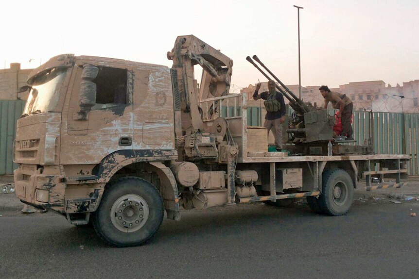 Islamic State of Iraq and the Levant (ISIS) fighters patrol on a vehicle in Tikrit on June 11, 2014.