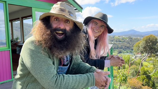 Costa and Hannah on Hannah's balcony overlooking Hobart city.