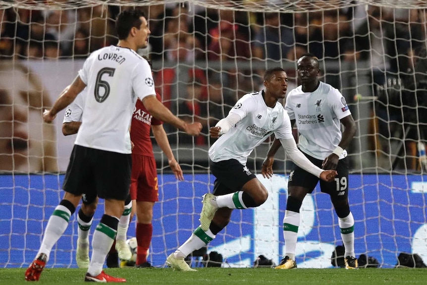 Liverpool's Georginio Wijnaldum (C), celebrates after scoring against Roma in the Champions League.
