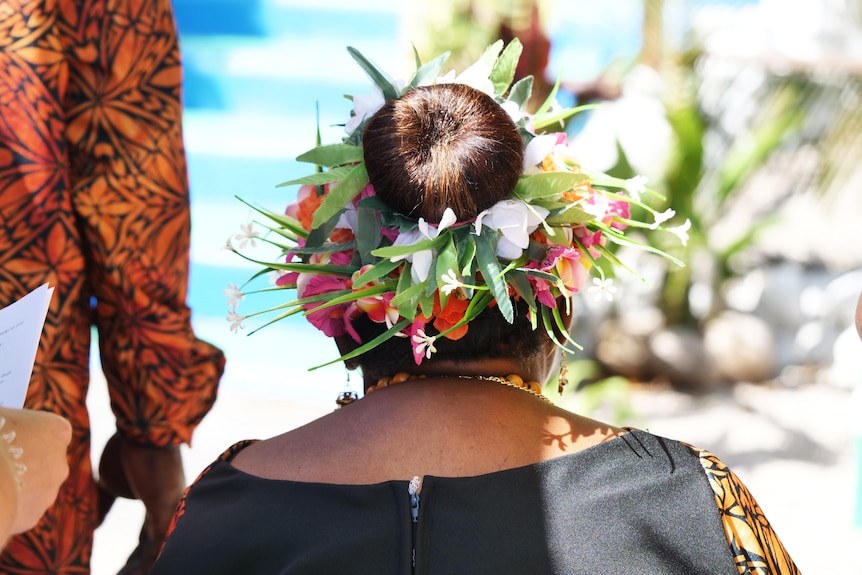 flowers surround a woman's hair bun.