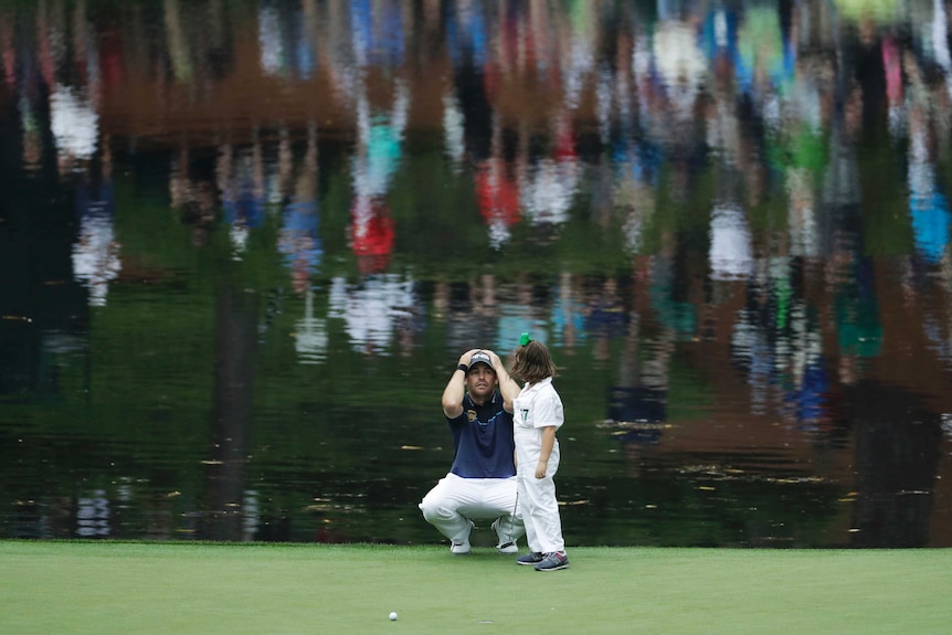 Louis Oosthuizen reacts in mock anguish after his daughter misses at Augusta