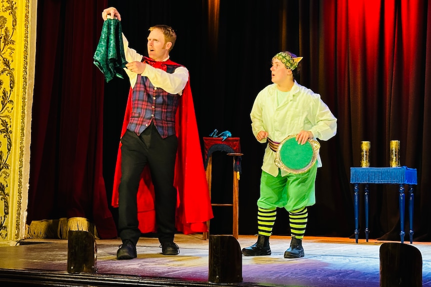 a man and woman in costumes mid performance