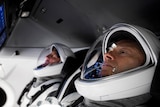 Two men in cockpit of spacecraft
