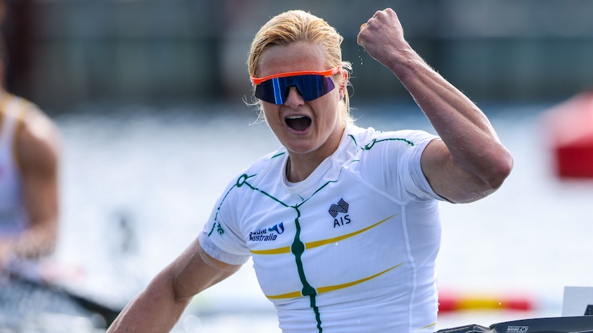 An Australian female sprint paddler pumps her right fist as she celebrates winning a world championship.