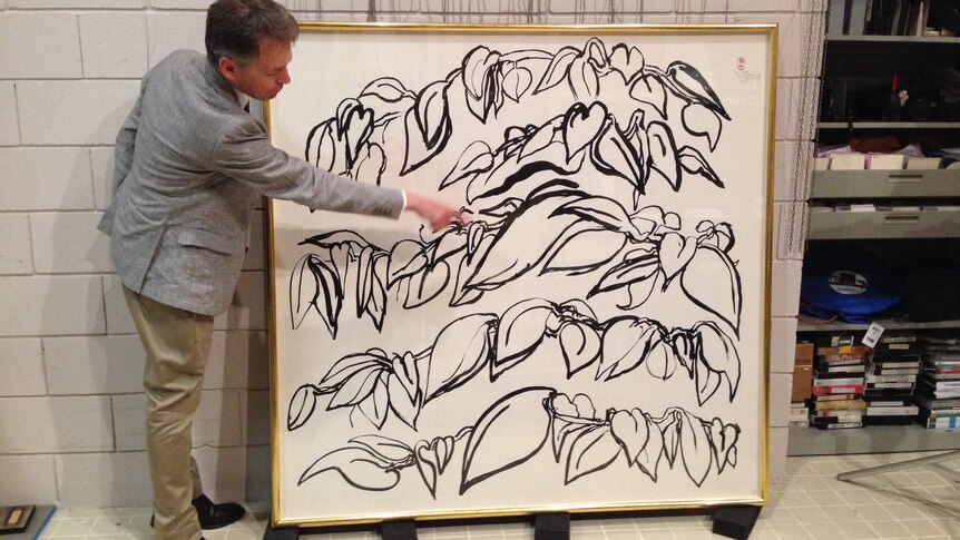Newcastle Art Gallery director Ron Ramsey shows off a recently donated Brett Whiteley work.
