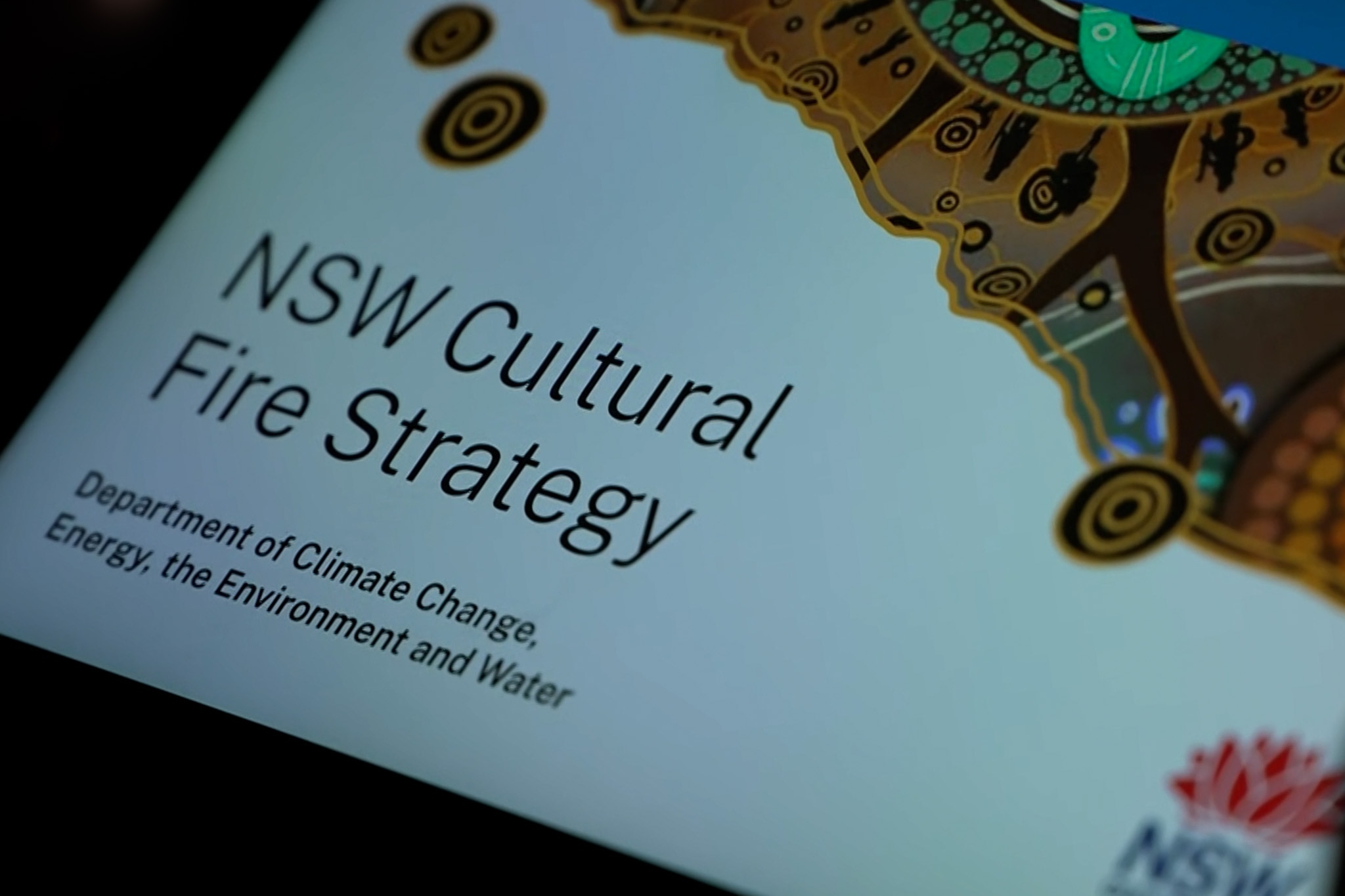 Close up of front page of government report on a tablet screen.