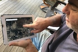 man pointing at a map on tablet