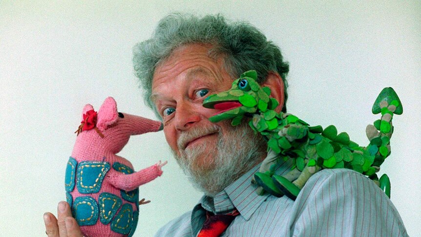 Peter Firmin with one of The Clangers in his hand and one on his shoulder