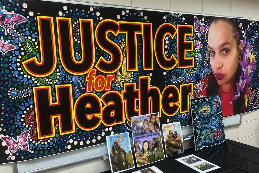 A banner reading "Justice for Heather" with a photo of Heather Calgaret alongside the words