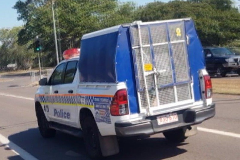 A picture of a police paddy wagon on the road