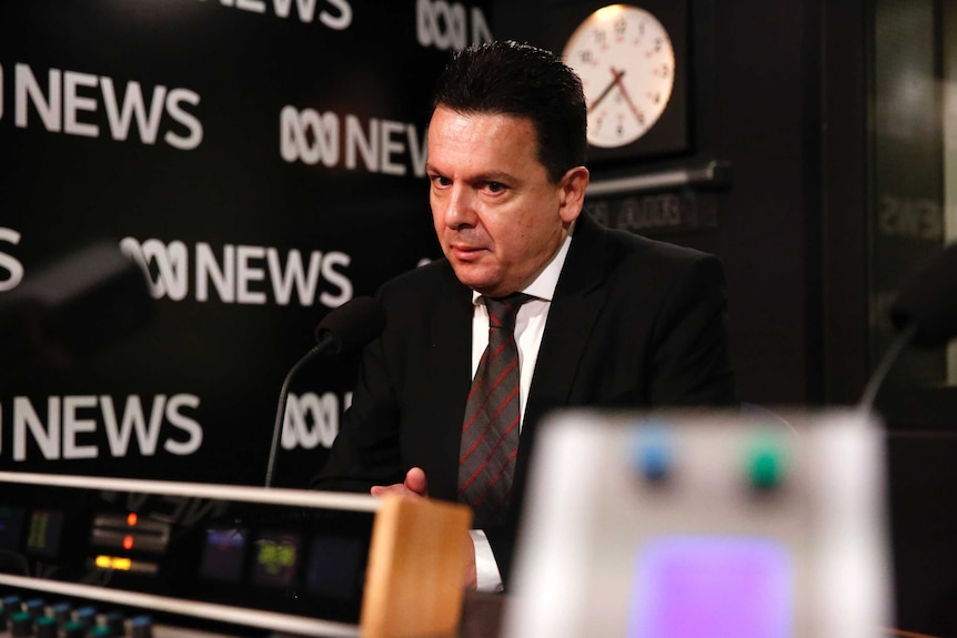 Concerned looking Nick Xenophon sitting in ABC Radio studio