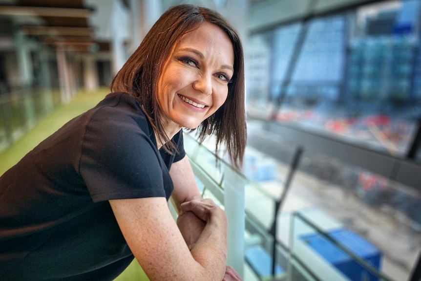 Pain specialist Dr Karen Hitchcock leaning on a hand rail.