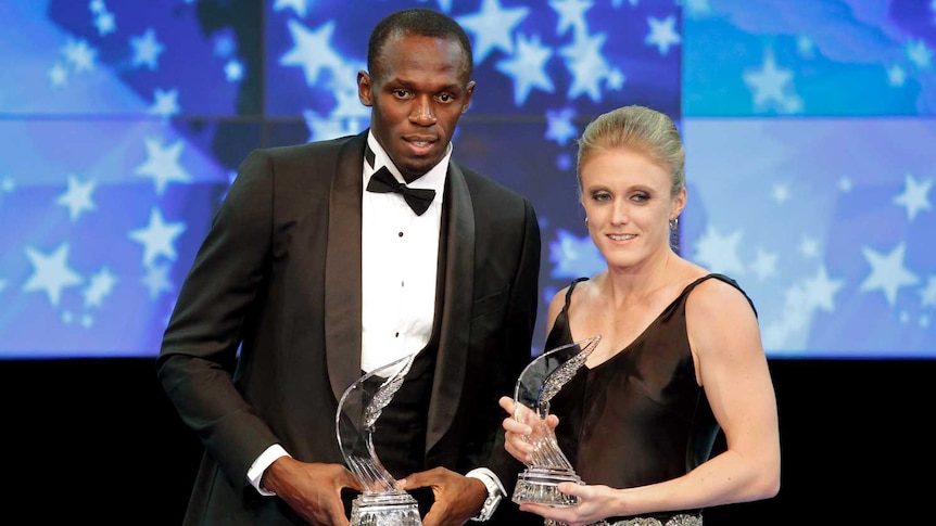 Bolt and Pearson pose with their awards