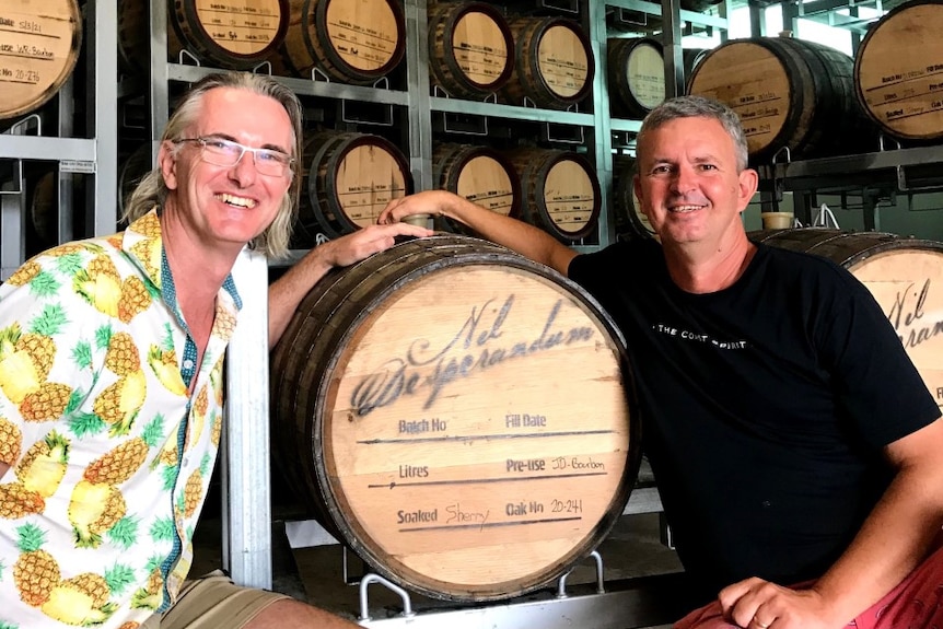 Photo of two men at a keg room.