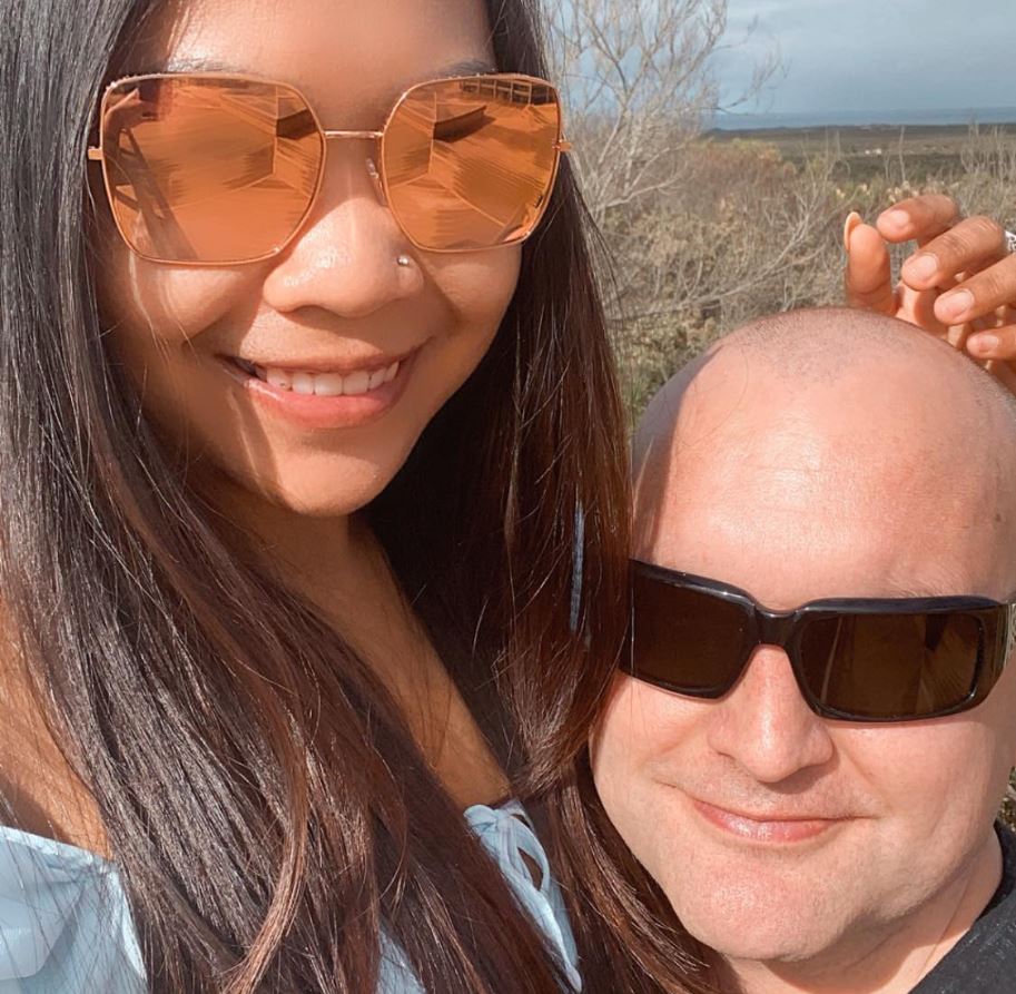 A man and a woman smile in a happy couple shot.