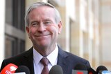A mid shot of Colin Barnett smiling outside Parliament House in Perth.