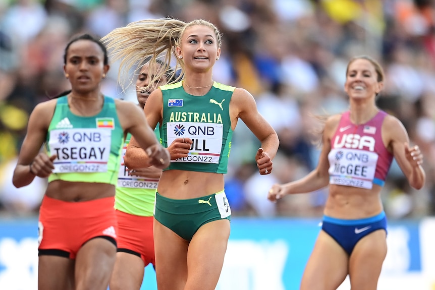 Four women cross the finish line in the 1,500m semifinals at the World Athletics Championships.