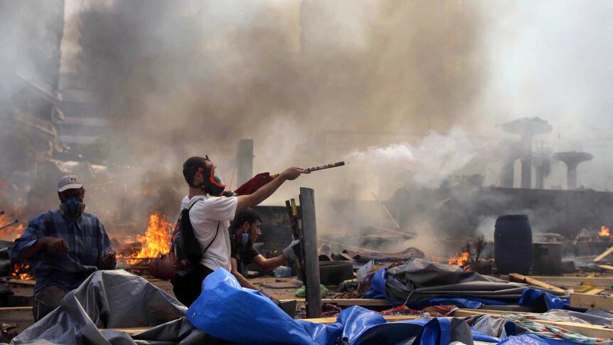 Muslim Brotherhood and Mohammed Morsi supporter shoots fireworks towards police during clashes.