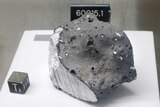 An anorthosite sample believed to be the oldest rock collected during the moon missions is displayed in the lunar lab.