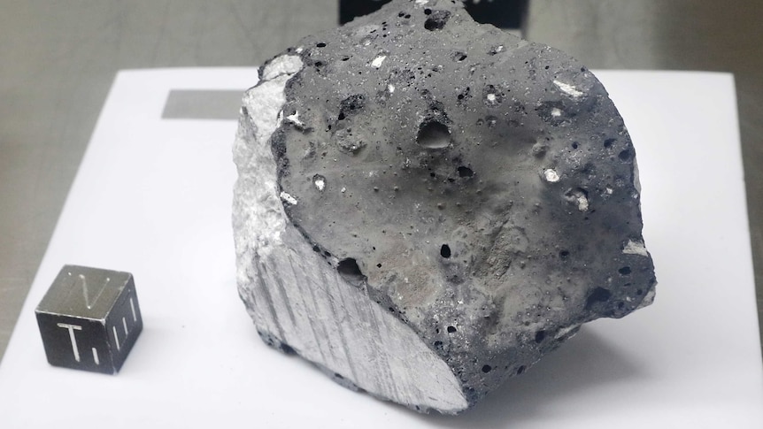An anorthosite sample believed to be the oldest rock collected during the moon missions is displayed in the lunar lab.