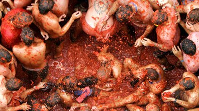 Revellers fight each other with tomatoes during the annual tomato fight in eastern Spain.