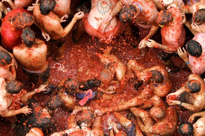 Revellers fight each other with tomatoes during the annual tomato fight in eastern Spain.