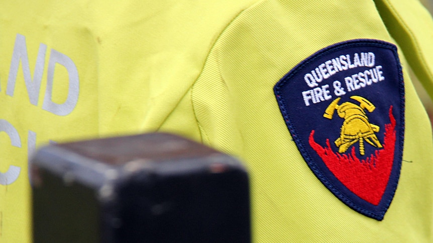 Queensland Fire & Rescue emblem on the shoulder of an officer.