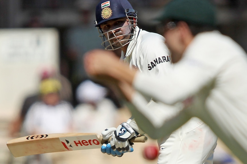 Dropped him: Sehwag watches on as Ed Cowan lets one slip at mid wicket.