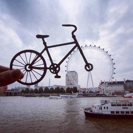 A photo of the London Eye with a bicycle cut out