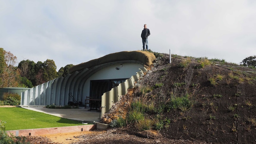 Nigel Kirkwood standing next to his Quindalup home