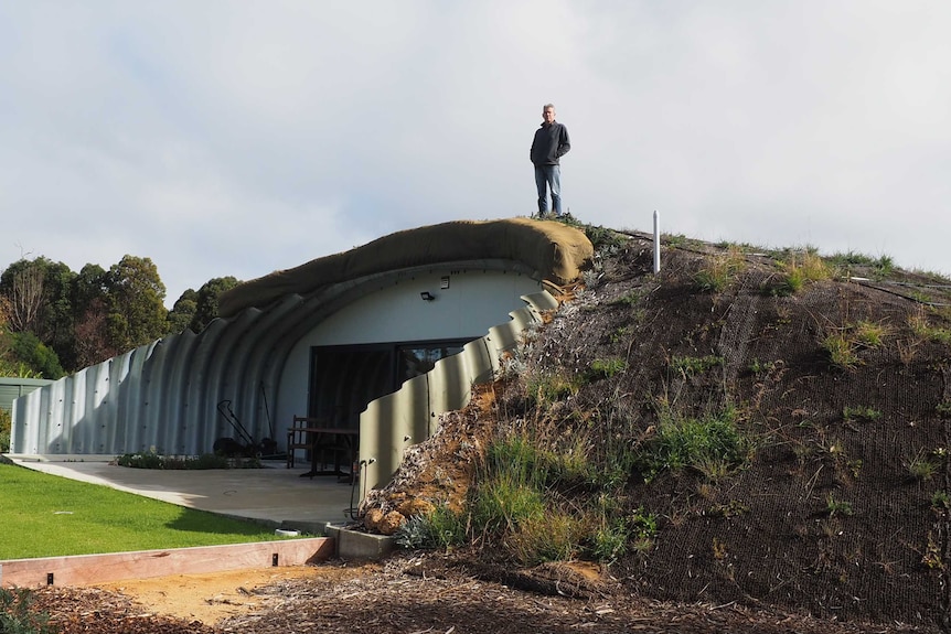 Nigel Kirkwood standing next to his Quindalup home