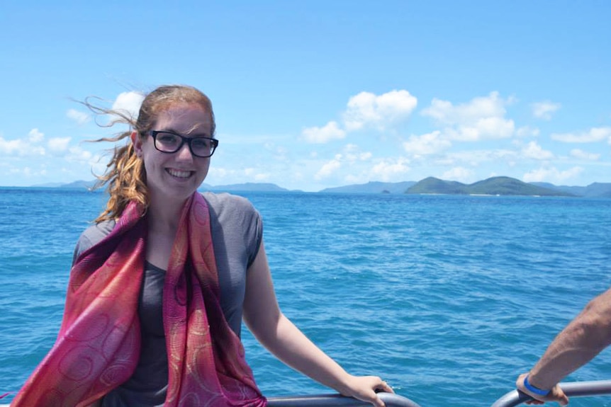 Alexandra Geelan leans on a railing with the ocean behind here in the Whitsundays in north Queensland.