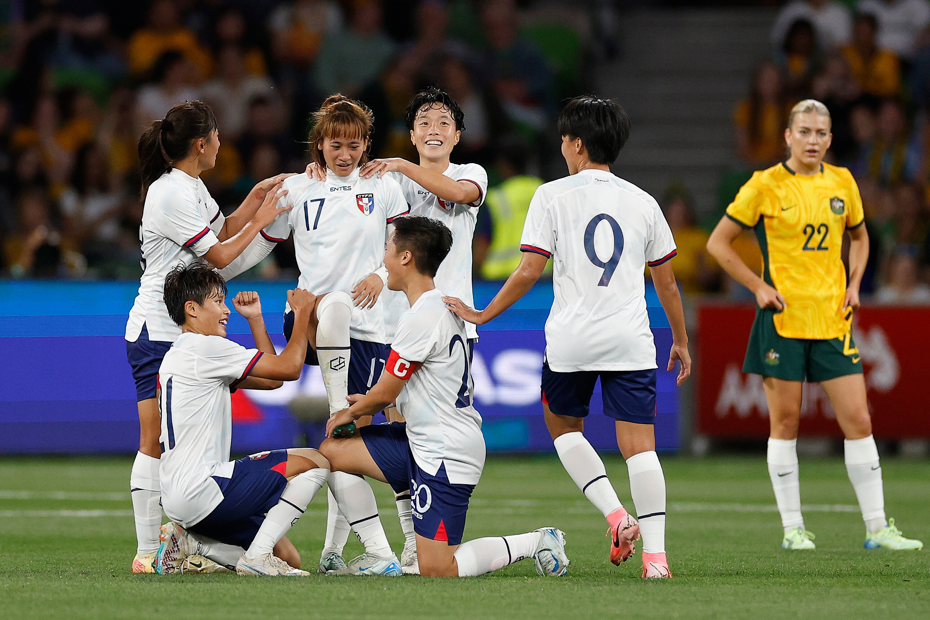 Taiwan players celebrate Chen Ji-Wen's goal as Matildas player Charli Grant stands in the background.