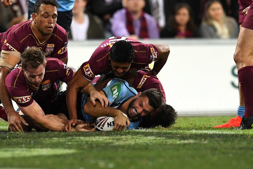 James Tedesco scores for the Blues agaqinst the Maroons