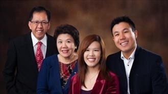 Curtis Cheng, wearing a suit, poses for a family photo.