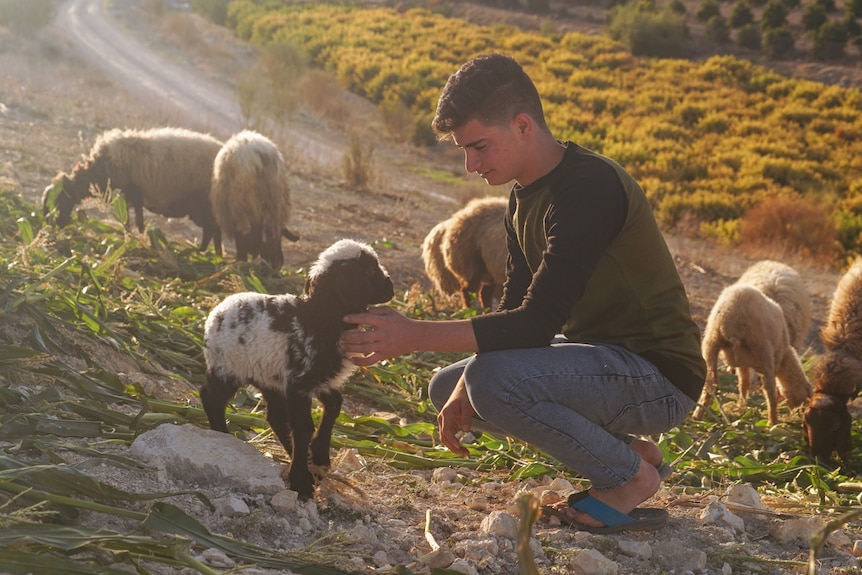 A boy with a lamb.