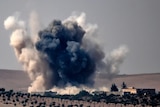 Smoke billows following air strikes by a Turkish Army jet fighter on the Syrian Turkish border village of Jarabulus.