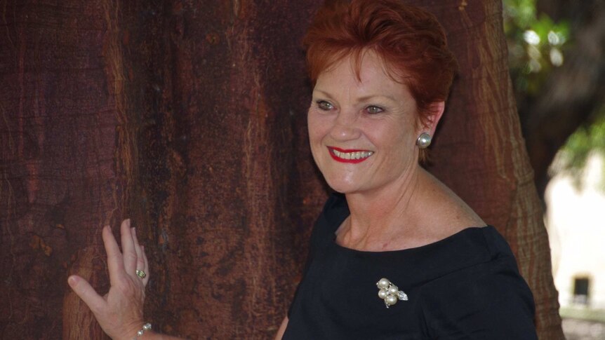 Pauline Hanson leaning against a tree in Perth