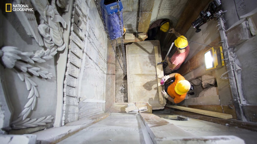 Overhead view of workers removing the marble top layer of the tomb said to be of Jesus Christ