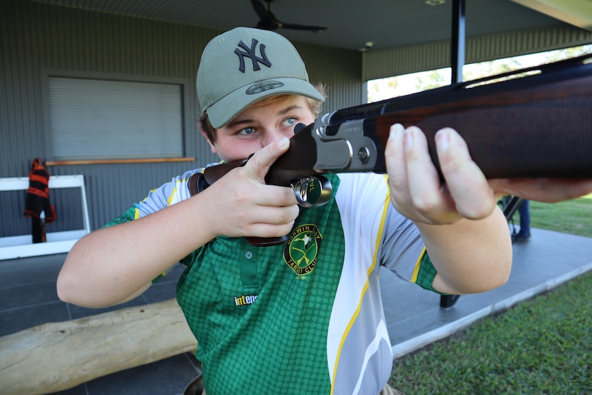 A close up shot of Les Harris aiming his gun.