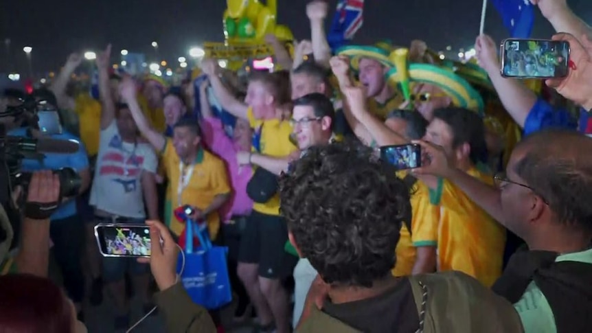 Socceroos fans celebrate victory over Denmark in Qatar