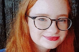 young red-head girl in glasses