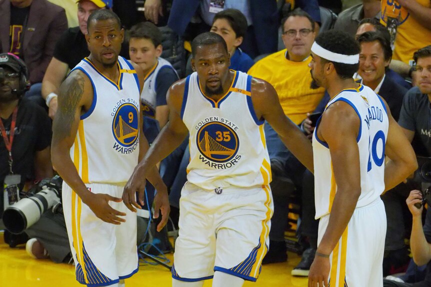 Kevin Durant (C) celebrates with Andre Iguodala (L) and James Michael McAdoo during the win.
