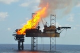 An oil platform engulfed in flames.