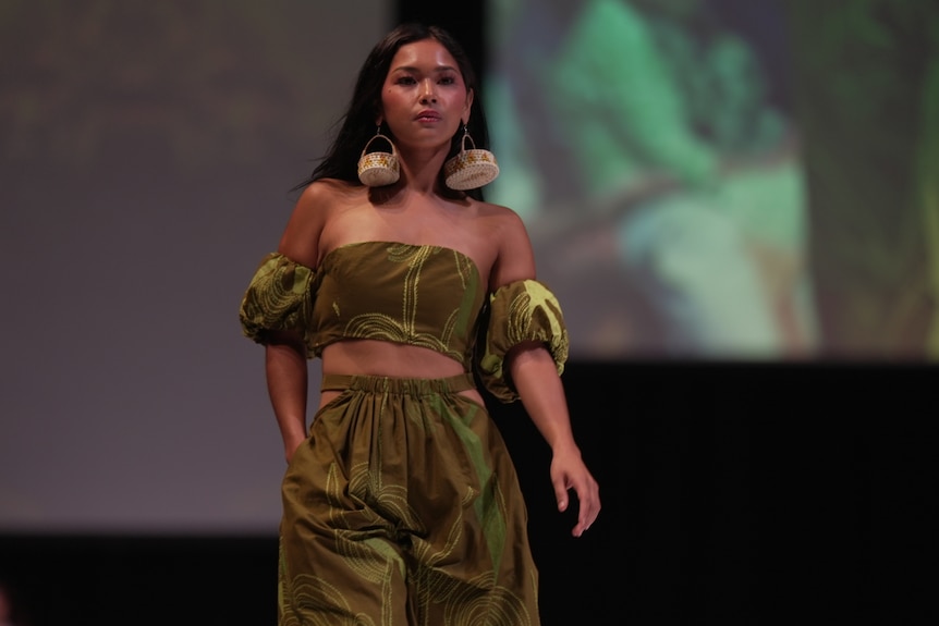 a female model wears an olive green two-piece