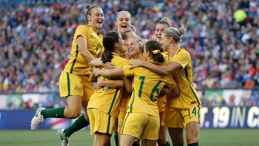 Australian players jump up together as they celebrate a goal against United States on July 27, 2017.