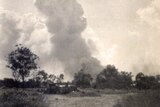 A smoke stack rises over Katherine after being bombed in 1942