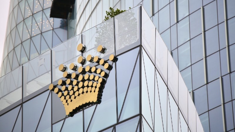 A tall building with a Crown logo.
