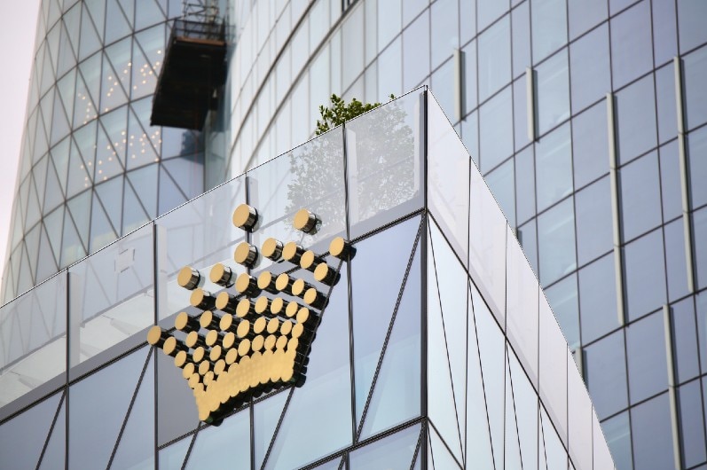 A tall building with a Crown logo.